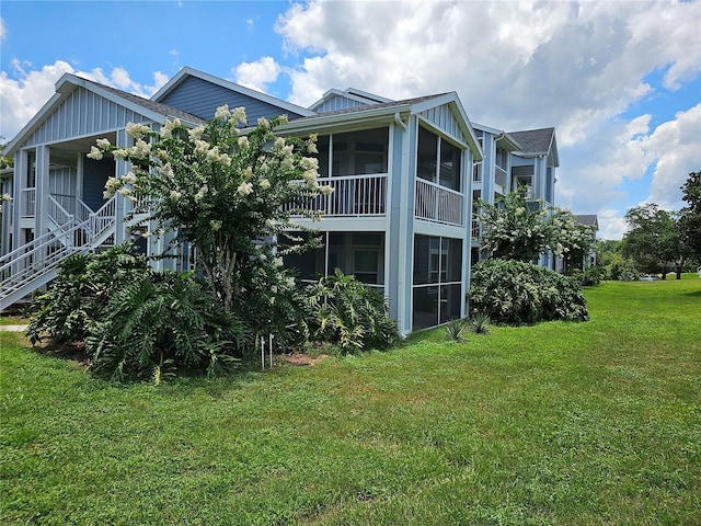 711 Sugar Bay Way Unit 115, Lake Mary, FL 32746 - back of house featuring a yard, a sunroom, and stairway