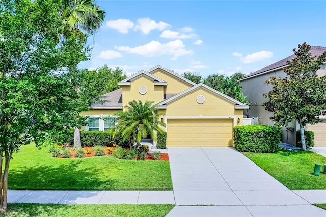 418 Rock Springs Cir, Groveland, FL 34736 - view of front of property with a garage, stucco siding, driveway, and a front yard