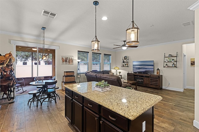 418 Rock Springs Cir, Groveland, FL 34736 - kitchen featuring ceiling fan, open floor plan, wood finished floors, crown molding, and a textured ceiling