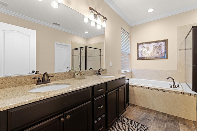 418 Rock Springs Cir, Groveland, FL 34736 - full bathroom featuring a stall shower, double vanity, a bath, wood finished floors, and crown molding