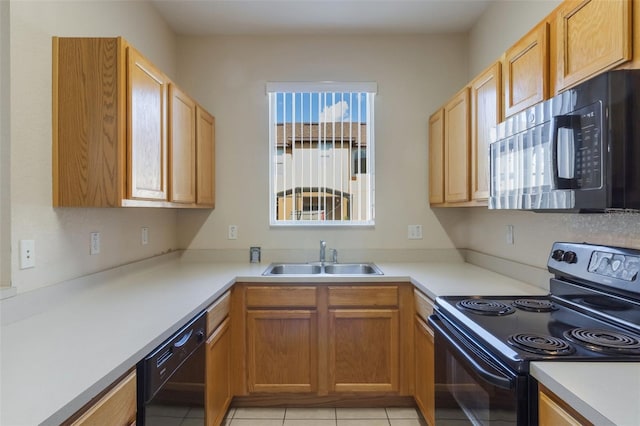 2717 Bushman Dr, Kissimmee, FL 34746 - kitchen with black appliances, light countertops, and light tile patterned floors