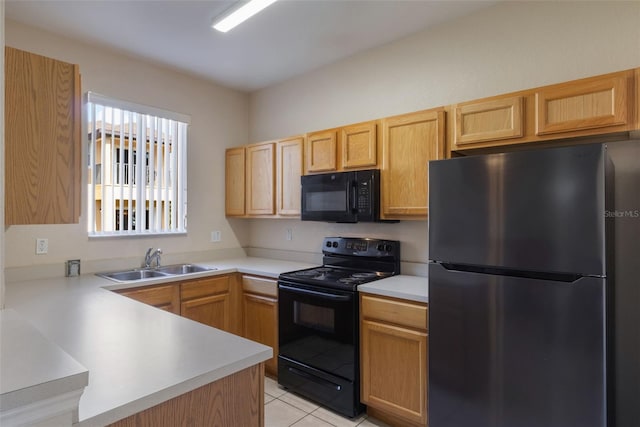 2717 Bushman Dr, Kissimmee, FL 34746 - kitchen featuring black appliances, light countertops, a peninsula, light tile patterned floors, and light brown cabinetry