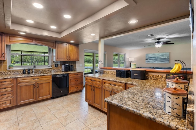 14325 Manchester Ave, Groveland, FL 34736 - kitchen featuring black dishwasher, brown cabinetry, decorative backsplash, light tile patterned flooring, and ceiling fan