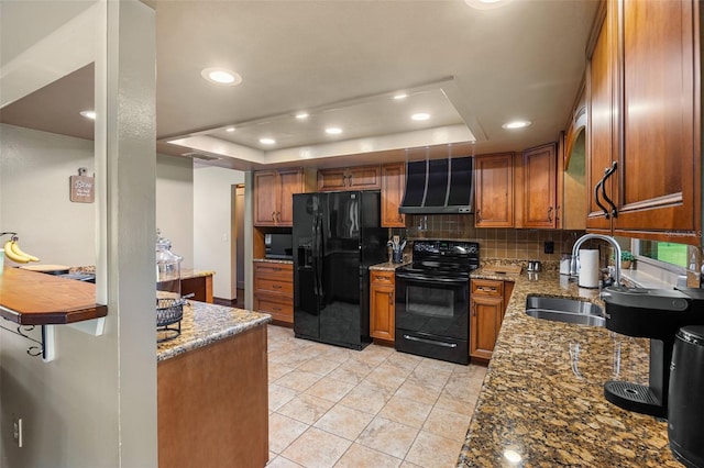 14325 Manchester Ave, Groveland, FL 34736 - kitchen featuring black appliances, wall chimney exhaust hood, brown cabinets, decorative backsplash, and a tray ceiling