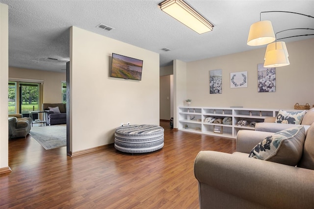 14325 Manchester Ave, Groveland, FL 34736 - living room featuring wood finished floors and a textured ceiling