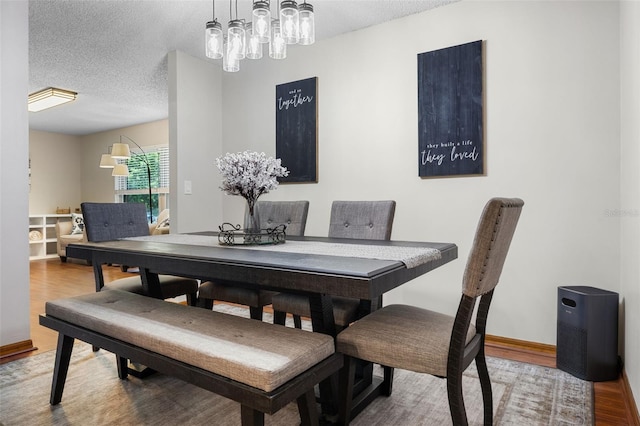 14325 Manchester Ave, Groveland, FL 34736 - dining space featuring wood finished floors and a textured ceiling