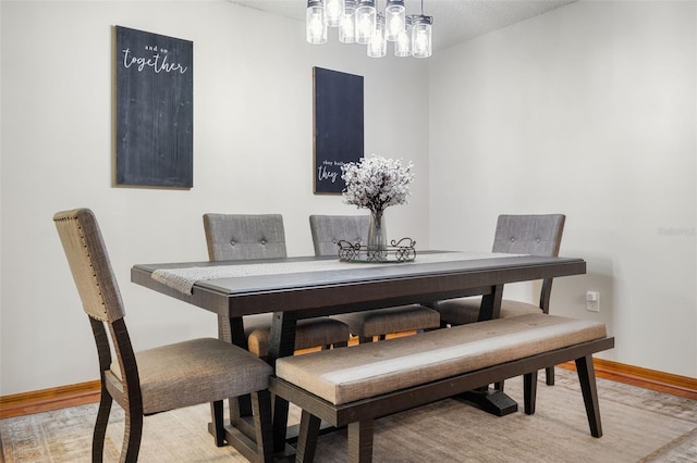 14325 Manchester Ave, Groveland, FL 34736 - dining room featuring light wood-style floors, a chandelier, and a textured ceiling