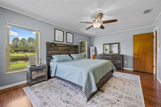 14325 Manchester Ave, Groveland, FL 34736 - bedroom featuring multiple windows, wood finished floors, ornamental molding, a textured ceiling, and ceiling fan