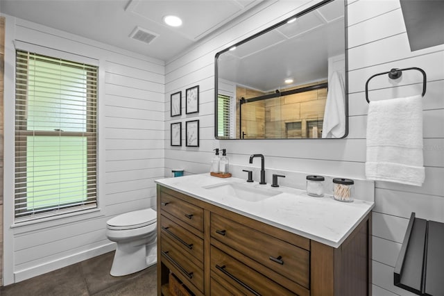 14325 Manchester Ave, Groveland, FL 34736 - bathroom with vanity, a shower with shower door, wood walls, plenty of natural light, and tile patterned flooring