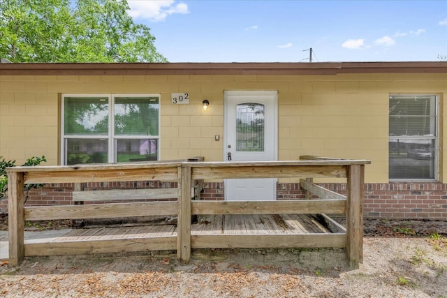 302 W Rose Ln, Lady Lake, FL 32159 - doorway to property with a deck and concrete block siding