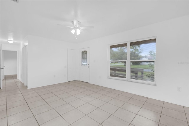 302 W Rose Ln, Lady Lake, FL 32159 - empty room with ceiling fan and light tile patterned flooring
