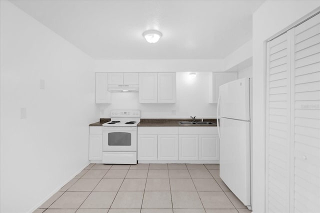 302 W Rose Ln, Lady Lake, FL 32159 - kitchen featuring white appliances, under cabinet range hood, dark countertops, white cabinets, and light tile patterned flooring