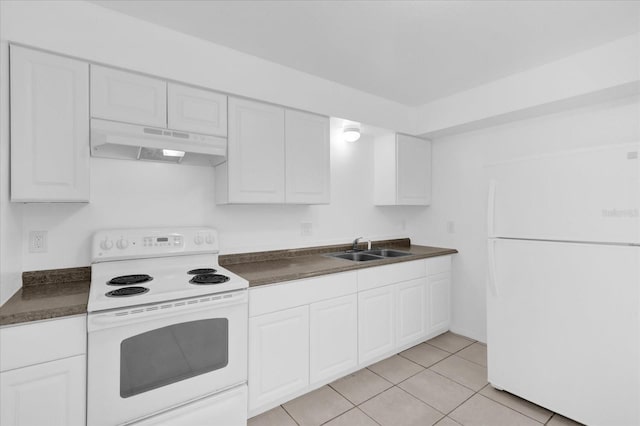 302 W Rose Ln, Lady Lake, FL 32159 - kitchen featuring white appliances, under cabinet range hood, dark countertops, white cabinets, and light tile patterned floors