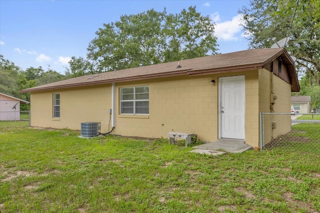 302 W Rose Ln, Lady Lake, FL 32159 - back of house featuring concrete block siding and roof with shingles