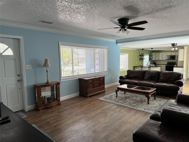 219 Magnolia Cir, Eustis, FL 32726 - living area featuring ornamental molding, a ceiling fan, wood finished floors, and a textured ceiling