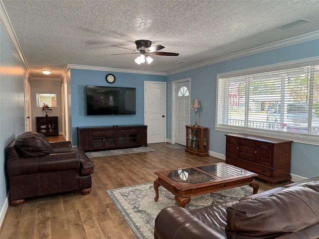 219 Magnolia Cir, Eustis, FL 32726 - living area with wood finished floors, crown molding, a textured ceiling, and a ceiling fan