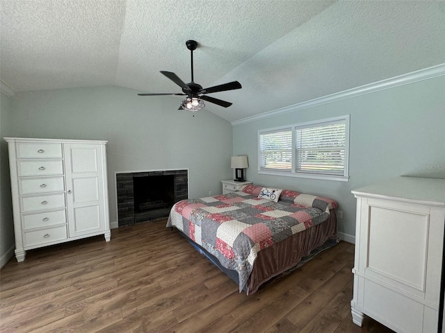 219 Magnolia Cir, Eustis, FL 32726 - bedroom featuring wood finished floors, a textured ceiling, vaulted ceiling, a fireplace, and ornamental molding