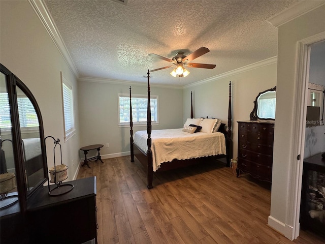 219 Magnolia Cir, Eustis, FL 32726 - bedroom featuring wood finished floors, a textured ceiling, ornamental molding, and ceiling fan