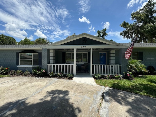 219 Magnolia Cir, Eustis, FL 32726 - view of front of property with covered porch and brick siding