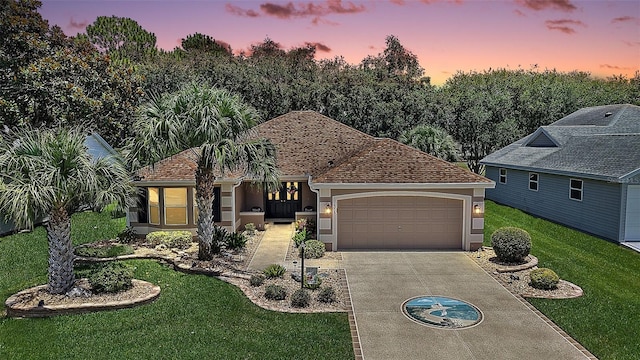 1309 Corona Ave, The Villages, FL 32159 - view of front of house with stucco siding, concrete driveway, a lawn, and an attached garage