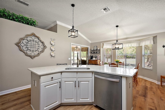 1309 Corona Ave, The Villages, FL 32159 - kitchen with dishwasher, ornamental molding, a textured ceiling, lofted ceiling, and hanging light fixtures