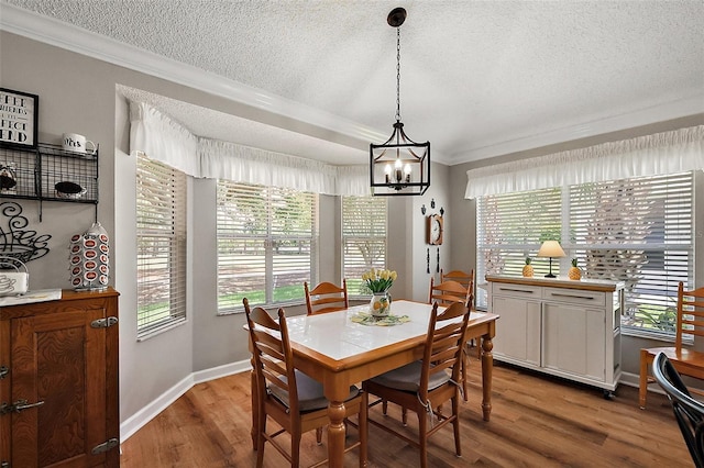 1309 Corona Ave, The Villages, FL 32159 - dining area with a textured ceiling, crown molding, a chandelier, and wood finished floors