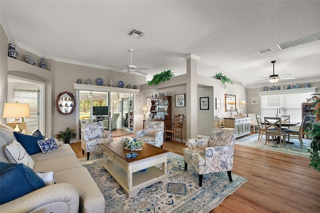 1309 Corona Ave, The Villages, FL 32159 - living area featuring a ceiling fan, plenty of natural light, crown molding, and a textured ceiling