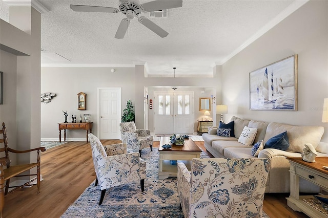 1309 Corona Ave, The Villages, FL 32159 - living room featuring crown molding, wood finished floors, ceiling fan, and a textured ceiling