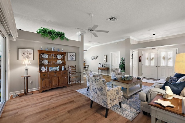 1309 Corona Ave, The Villages, FL 32159 - living area with a textured ceiling, light wood-style floors, ornamental molding, and ceiling fan