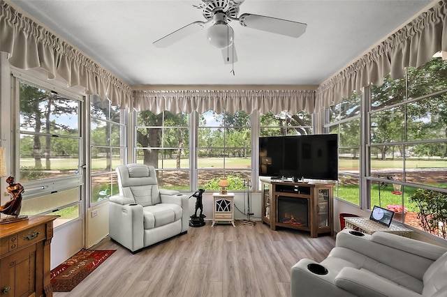 1309 Corona Ave, The Villages, FL 32159 - sunroom / solarium featuring ceiling fan, healthy amount of natural light, and a warm lit fireplace