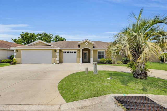 12407 NE 48th Loop, Oxford, FL 34484 - view of front of house with driveway, a garage, stucco siding, and a front yard