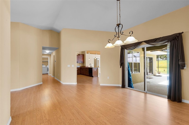 12407 NE 48th Loop, Oxford, FL 34484 - unfurnished dining area with light wood-type flooring, arched walkways, a chandelier, and lofted ceiling