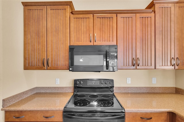 12407 NE 48th Loop, Oxford, FL 34484 - kitchen with black appliances, brown cabinetry, and light stone countertops