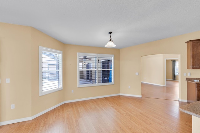 12407 NE 48th Loop, Oxford, FL 34484 - unfurnished living room featuring light wood-type flooring and baseboards