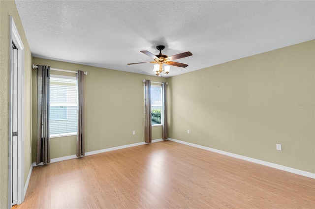 12407 NE 48th Loop, Oxford, FL 34484 - spare room featuring light wood finished floors, a textured ceiling, and a ceiling fan
