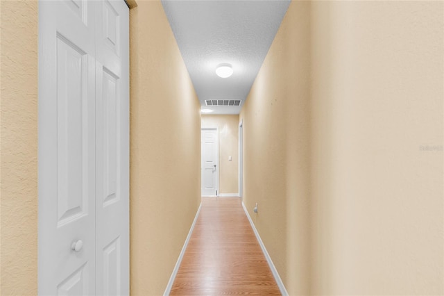 12407 NE 48th Loop, Oxford, FL 34484 - hall featuring wood finished floors and a textured ceiling