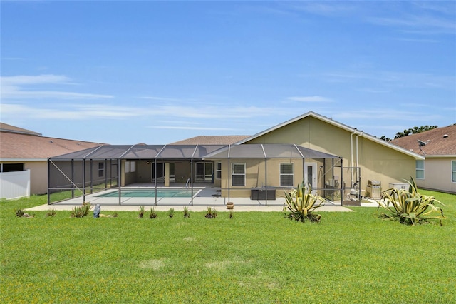 12407 NE 48th Loop, Oxford, FL 34484 - rear view of property with a lawn, a patio, an outdoor pool, and a lanai