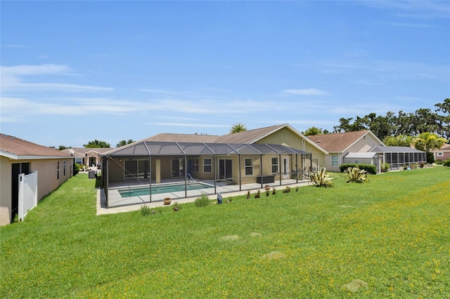 12407 NE 48th Loop, Oxford, FL 34484 - rear view of house featuring a yard and glass enclosure