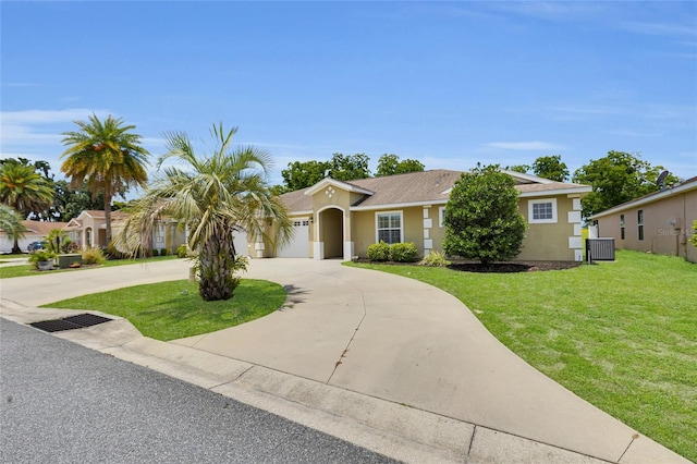 12407 NE 48th Loop, Oxford, FL 34484 - view of front of property featuring curved driveway, a front lawn, stucco siding, and a garage