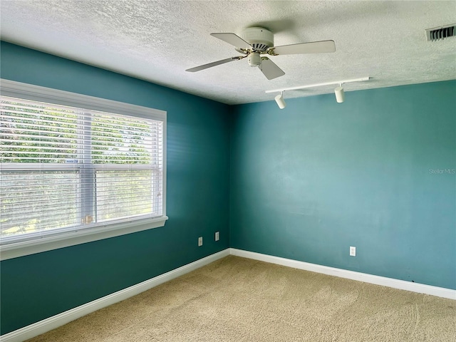 1096 Linkside Ct, Apopka, FL 32712 - unfurnished room featuring a textured ceiling, a ceiling fan, carpet, and rail lighting