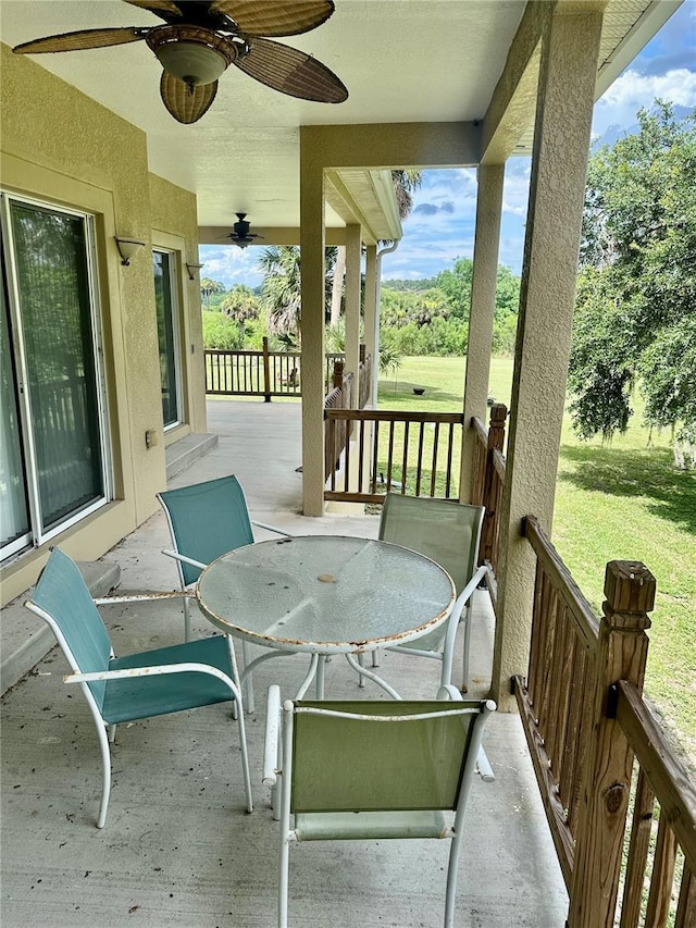 1096 Linkside Ct, Apopka, FL 32712 - covered porch featuring a ceiling fan, a yard, and outdoor dining area