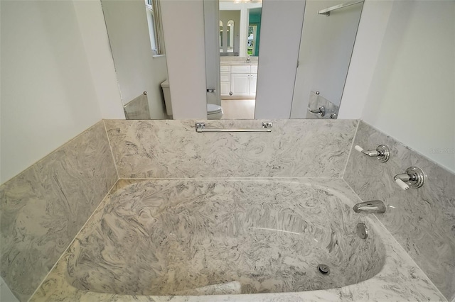 1512 Cervantes Pl, The Villages, FL 32159 - full bathroom with a tub with marble appearance and vanity