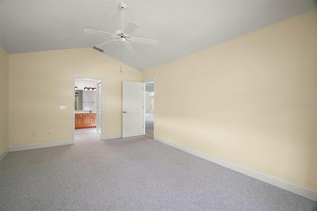1512 Cervantes Pl, The Villages, FL 32159 - unfurnished bedroom featuring vaulted ceiling, light carpet, connected bathroom, and a ceiling fan