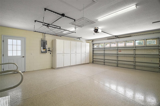 1512 Cervantes Pl, The Villages, FL 32159 - garage featuring electric panel, a garage door opener, and concrete block wall