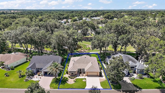 1512 Cervantes Pl, The Villages, FL 32159 - aerial perspective of suburban area featuring property parcel outlined and a forest