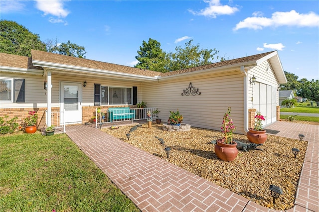 17970 SE 102nd Ct, Summerfield, FL 34491 - ranch-style house featuring covered porch, an attached garage, brick siding, a front yard, and driveway