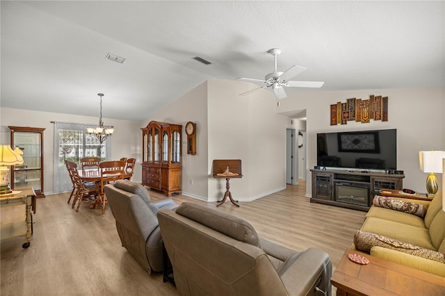 17970 SE 102nd Ct, Summerfield, FL 34491 - living room with light wood-type flooring, vaulted ceiling, a chandelier, and a ceiling fan