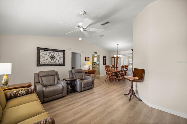 17970 SE 102nd Ct, Summerfield, FL 34491 - living room with light wood finished floors, vaulted ceiling, a chandelier, and a ceiling fan