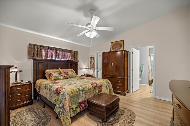 17970 SE 102nd Ct, Summerfield, FL 34491 - bedroom with light wood finished floors, vaulted ceiling, ceiling fan, and connected bathroom
