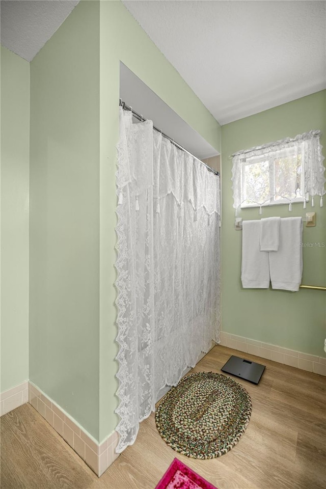 17970 SE 102nd Ct, Summerfield, FL 34491 - bathroom featuring wood finished floors and curtained shower